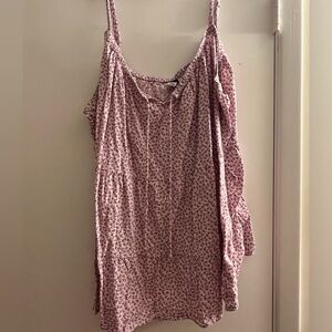 A light purple tank top with an open strings on chest